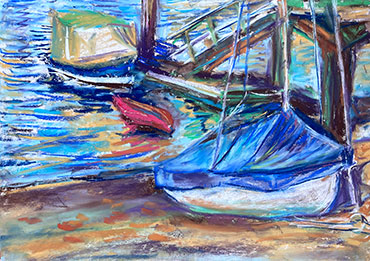 Boats tied to a dock with one beached due to a diminshing tide; sunset colors glimmer on the water.